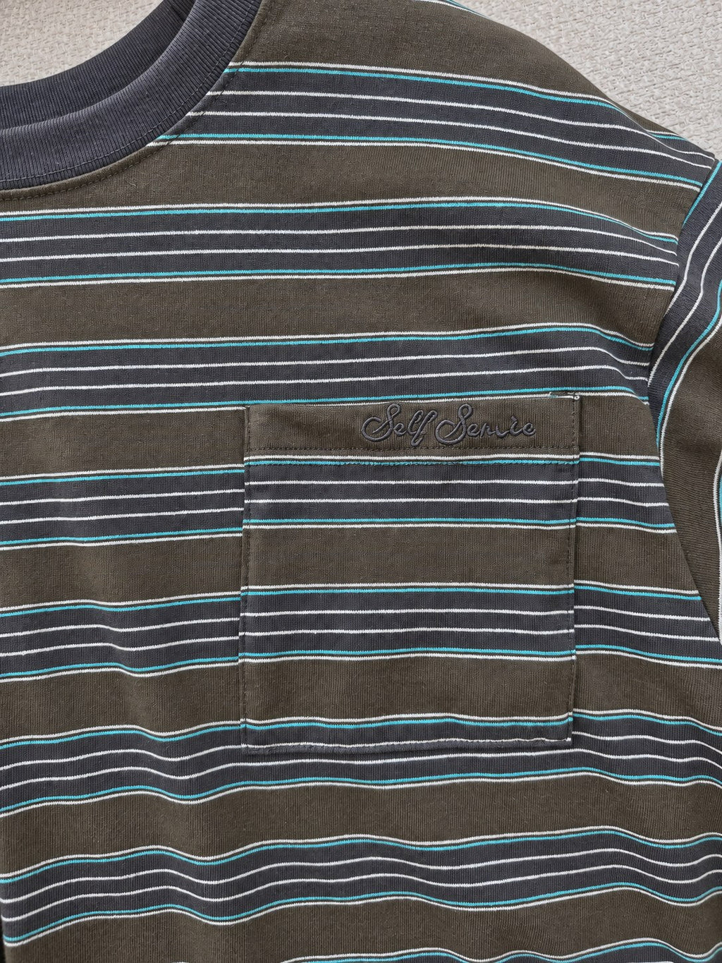Striped Pocket Tee — Green stripe, pocket detail