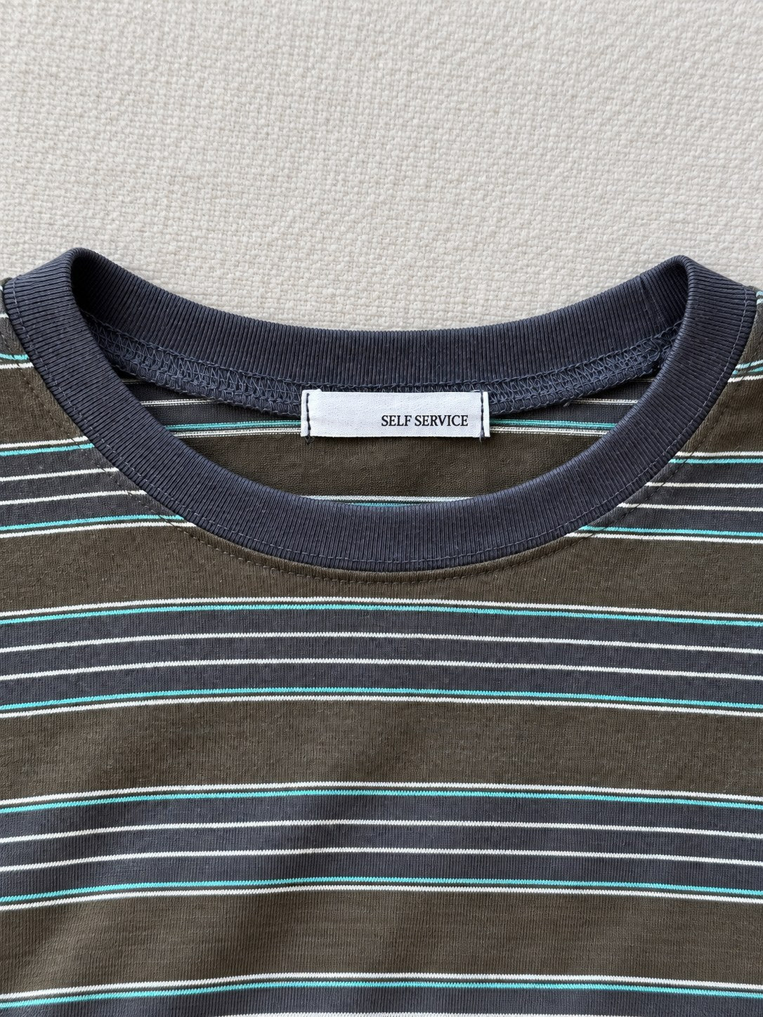 Striped Pocket Tee — Green stripe, neckline detail